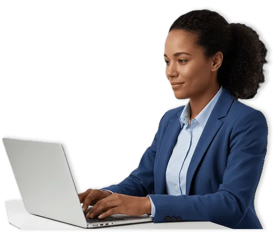 Woman in blue blazer working on a laptop at a desk.